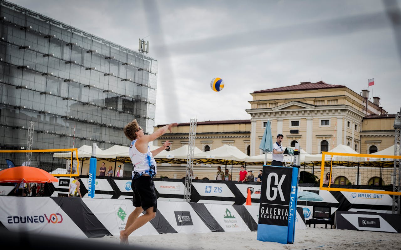 Exciting beach volleyball action captured in a bustling city environment.